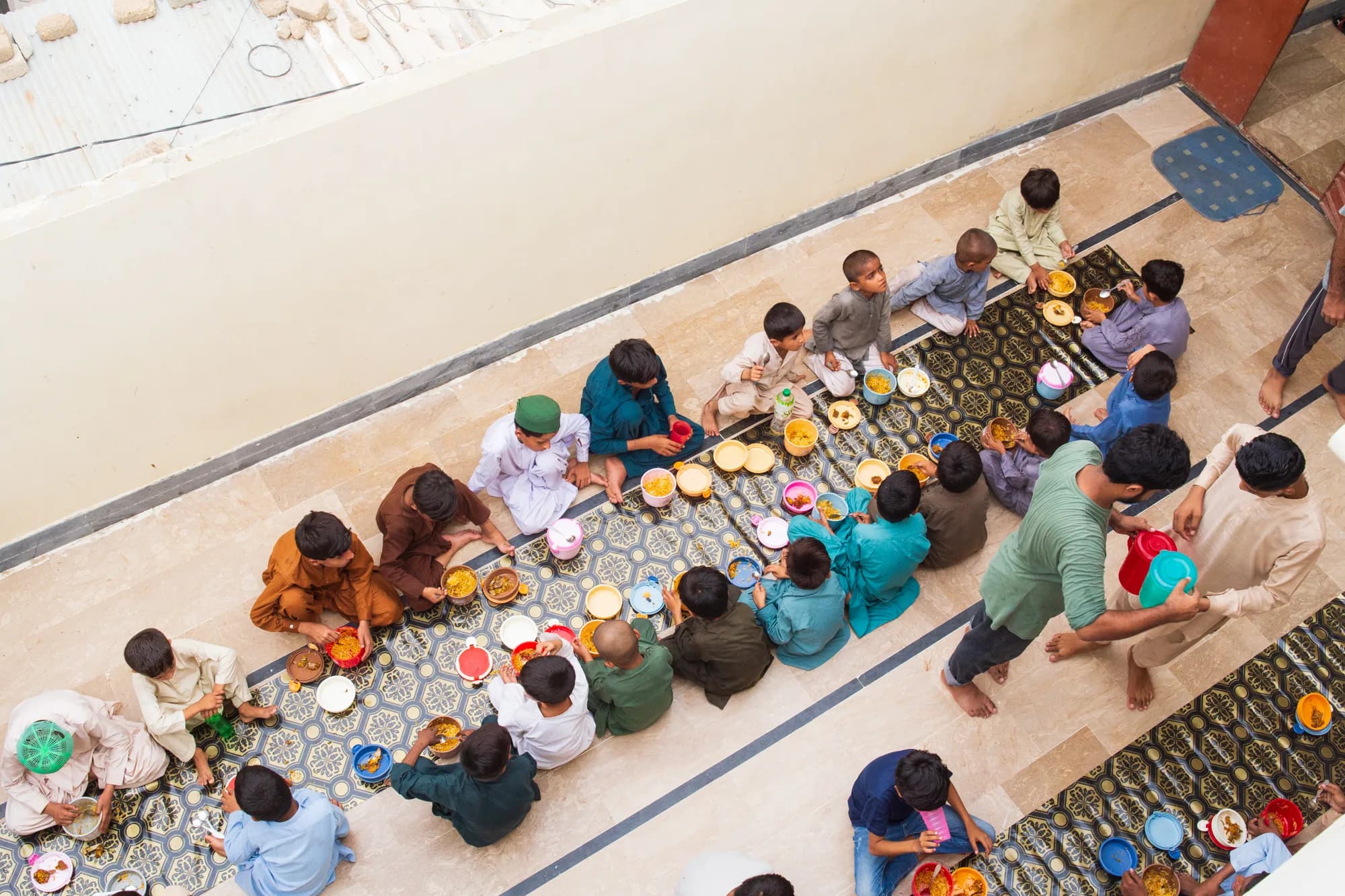 NourishEd staff serving the first meals at Library of Ibrahim Goth